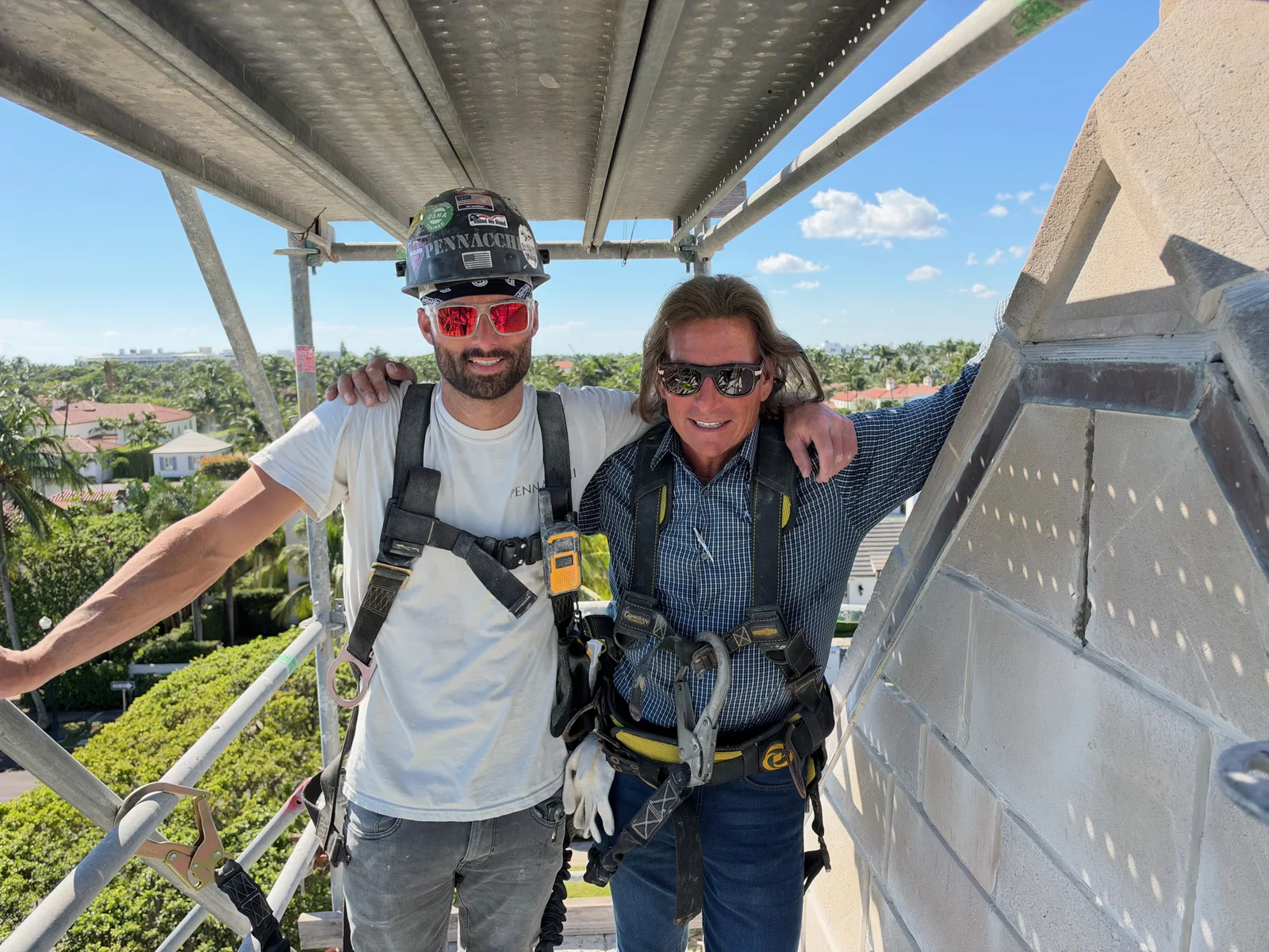 Paul Pennacchi Sr. and Paul Pennacchi Jr. on the scaffolding above the stonework at the Church of Bethesda-by-the-Sea in Palm Beach, Florida