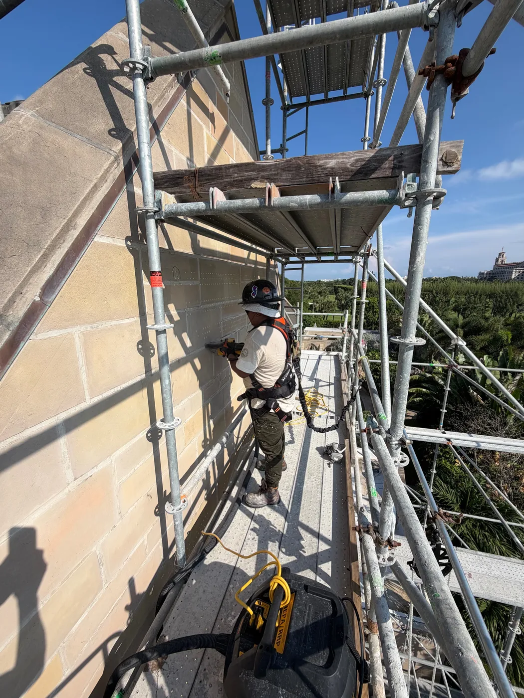 A mason cutting out damaged stone on the scaffolding at the Church of Bethesda-by-the-Sea in Palm Beach