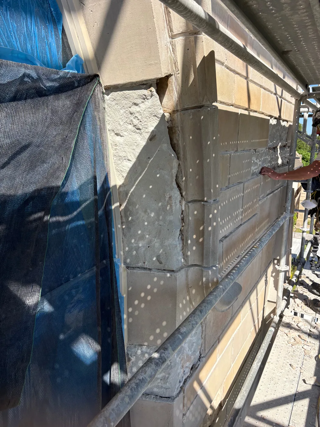 Close view of damaged stone being repaired and the joints repointed at Bethesda-by-the-Sea in Palm Beach, Florida