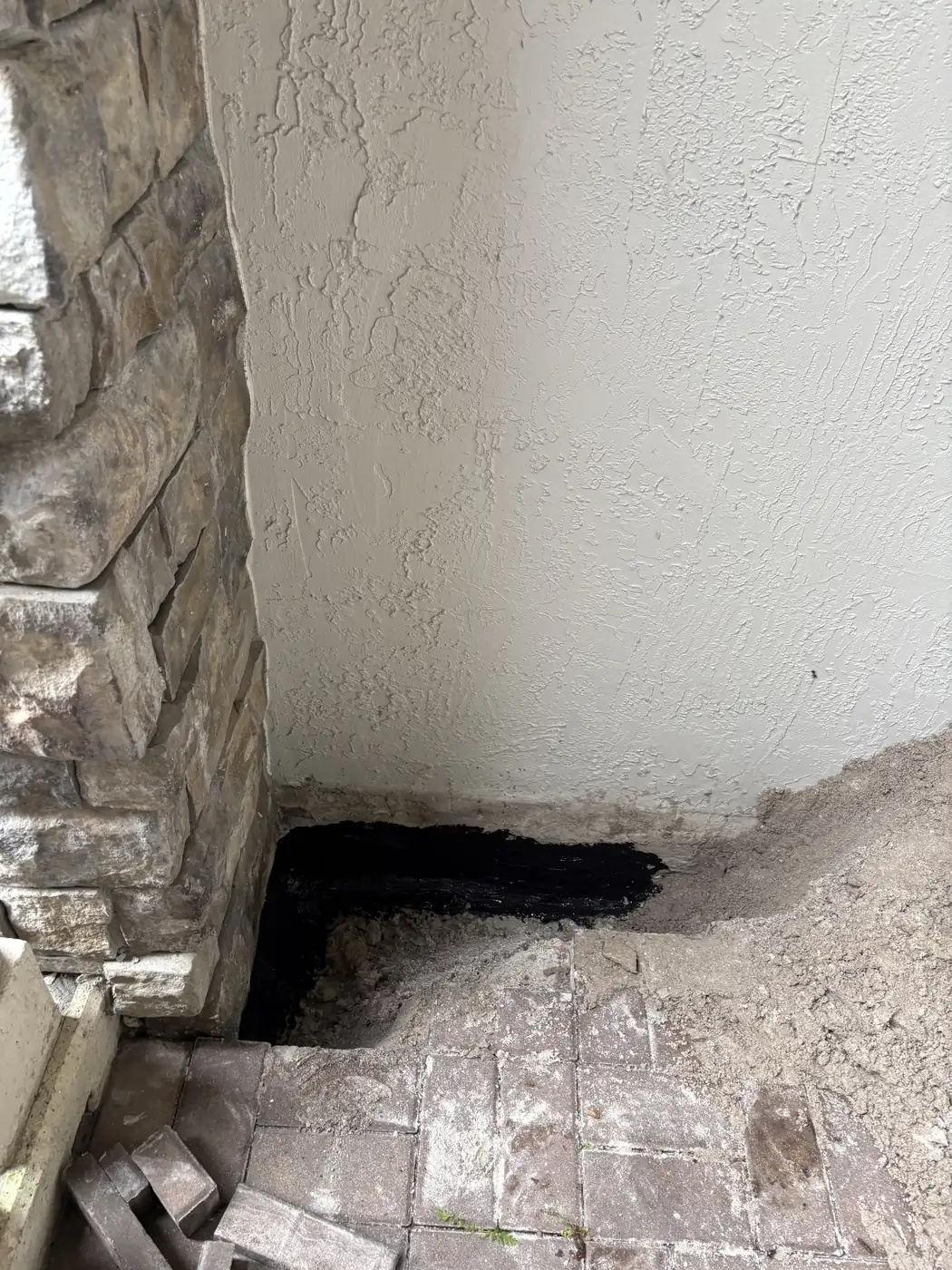 Completed Foundation Waterproofing Behind Stucco Wall